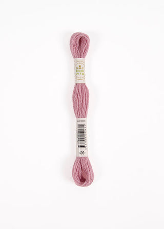 A skein of DMC wool Embroidery Floss in the color 'Dusty Pink' (number 469), shown vertically on a clean white background with its paper label visible.