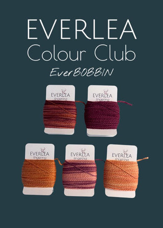 Everlea yarn on bobbins with branding on a dark background